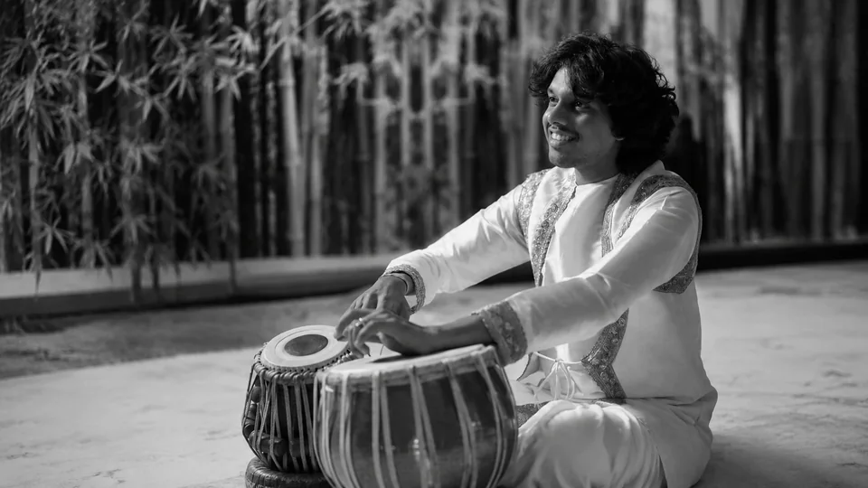 The musician pictured in the event programme playing tabla